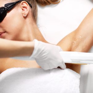 Picture Of Beautician Giving Epilation Laser Treatment To Woman On Armpits